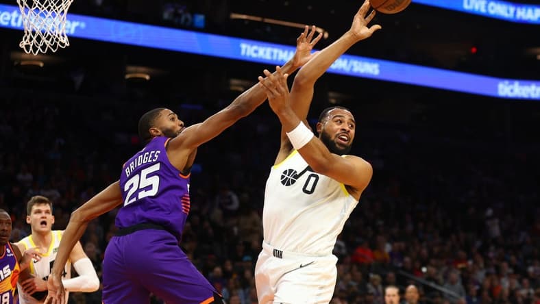 Nov 26, 2022; Phoenix, Arizona, USA; Utah Jazz guard Talen Horton-Tucker (0) passes the ball against Phoenix Suns forward Mikal Bridges (25) in the first half at Footprint Center. Mandatory Credit: Mark J. Rebilas-USA TODAY Sports