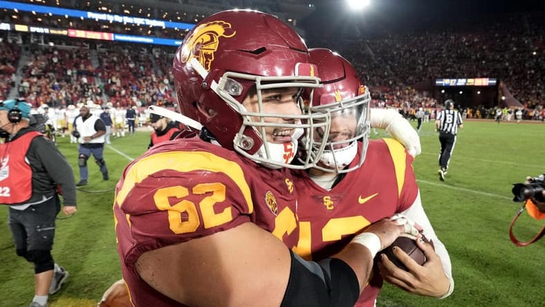 Nov 26, 2022; Los Angeles, California, USA; Southern California Trojans quarterback Caleb Williams (13) and offensive lineman Brett Neilon (62) celebrate after the game against the Notre Dame Fighting Irish at United Airlines Field at Los Angeles Memorial Coliseum. Mandatory Credit: Kirby Lee-USA TODAY Sports
