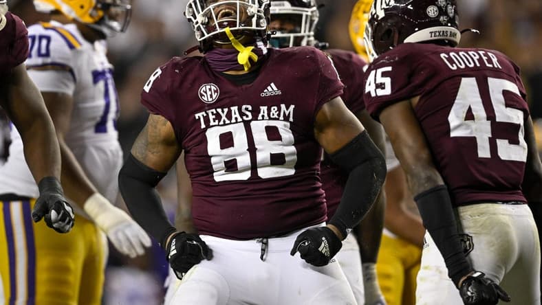 Nov 26, 2022; College Station, Texas, USA; Texas A&M Aggies defensive lineman Walter Nolen (88) and linebacker Edgerrin Cooper (45) celebrate a defensive stop against the LSU Tigers during the second half at Kyle Field. Mandatory Credit: Jerome Miron-USA TODAY Sports