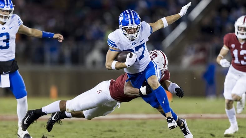 Nov 26, 2022; Stanford, California, USA; Brigham Young Cougars wide receiver Chase Roberts (27) runs the ball against Stanford Cardinal defensive end Aeneas DiCosmo (0) during the first half at Stanford Stadium. Mandatory Credit: John Hefti-USA TODAY Sports