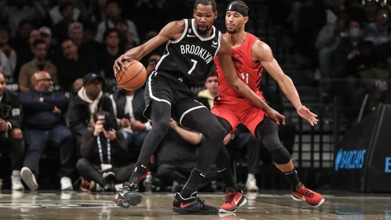 Nov 27, 2022; Brooklyn, New York, USA; Brooklyn Nets forward Kevin Durant (7) looks to spin away from Portland Trail Blazers guard Josh Hart (11) in the first quarter at Barclays Center. Mandatory Credit: Wendell Cruz-USA TODAY Sports
