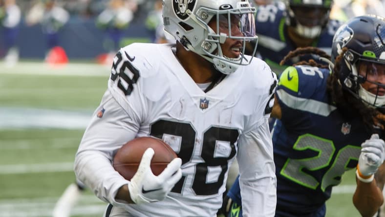 Nov 27, 2022; Seattle, Washington, USA; Las Vegas Raiders running back Josh Jacobs (28) rushes fora touchdown against the Seattle Seahawks during the second quarter at Lumen Field. Mandatory Credit: Joe Nicholson-USA TODAY Sports