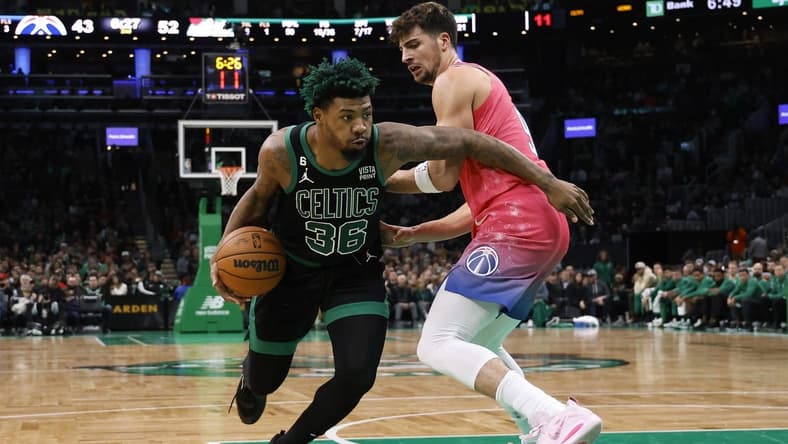 Nov 27, 2022; Boston, Massachusetts, USA; Boston Celtics guard Marcus Smart (36) goes past Washington Wizards forward Isaiah Todd (14) during the second quarter at TD Garden. Mandatory Credit: Winslow Townson-USA TODAY Sports
