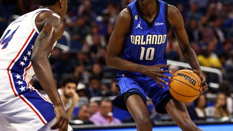 Nov 27, 2022; Orlando, Florida, USA; Orlando Magic center Bol Bol (10) drives to the basket as Philadelphia 76ers forward Paul Reed (44) defends during the second half at Amway Center. Mandatory Credit: Kim Klement-USA TODAY Sports