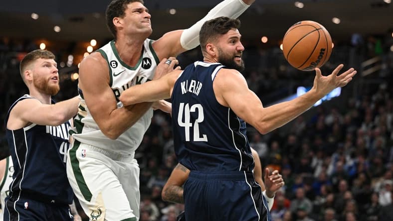 Nov 27, 2022; Milwaukee, Wisconsin, USA; Milwaukee Bucks center Brook Lopez (11) and Dallas Mavericks forward Maxi Kleber (42) battle for a rebound in the second quarter at Fiserv Forum. Mandatory Credit: Michael McLoone-USA TODAY Sports