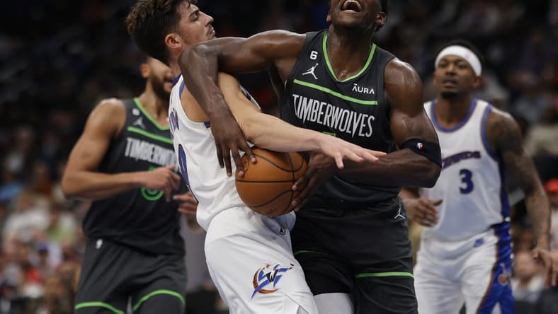 Nov 28, 2022; Washington, District of Columbia, USA; Minnesota Timberwolves guard Anthony Edwards (1) is fouled by Washington Wizards forward Deni Avdija (9) in the second quarter at Capital One Arena. Mandatory Credit: Geoff Burke-USA TODAY Sports