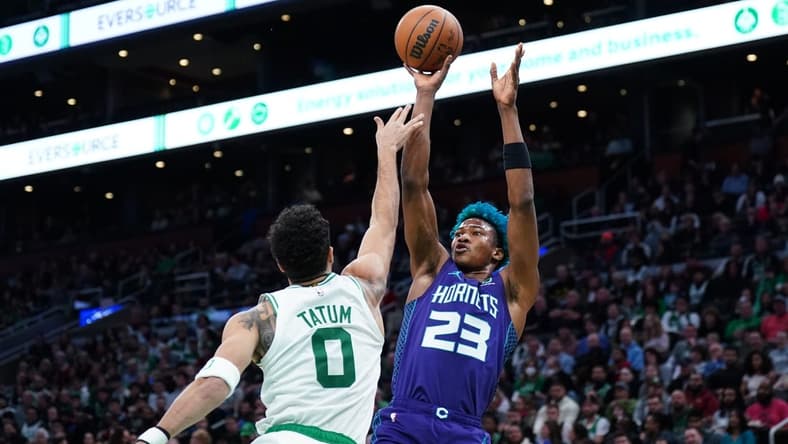 Nov 28, 2022; Boston, Massachusetts, USA; Charlotte Hornets forward Kai Jones (23) shoots against Boston Celtics forward Jayson Tatum (0) in the second quarter at TD Garden. Mandatory Credit: David Butler II-USA TODAY Sports