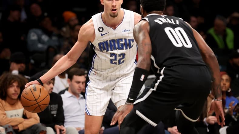 Nov 28, 2022; Brooklyn, New York, USA; Orlando Magic forward Franz Wagner (22) controls the ball against Brooklyn Nets forward Royce O'Neale (00) during the second quarter at Barclays Center. Mandatory Credit: Brad Penner-USA TODAY Sports