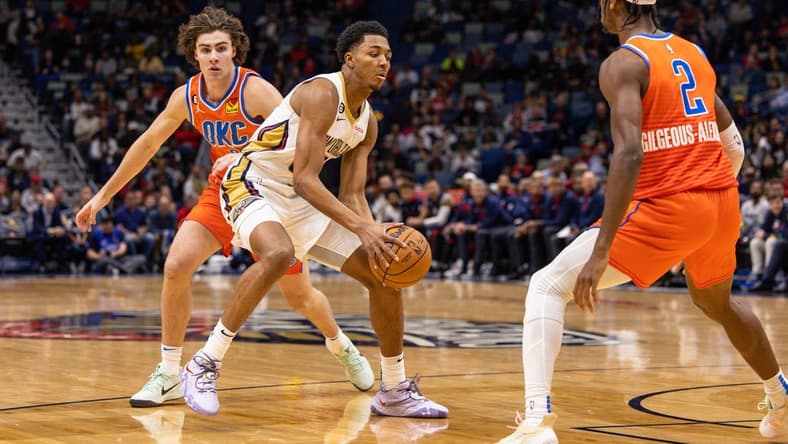 Nov 28, 2022; New Orleans, Louisiana, USA; New Orleans Pelicans guard Trey Murphy III (25) dribbles against Oklahoma City Thunder guard Josh Giddey (3) and guard Shai Gilgeous-Alexander (2) during the first half at Smoothie King Center. Mandatory Credit: Stephen Lew-USA TODAY Sports