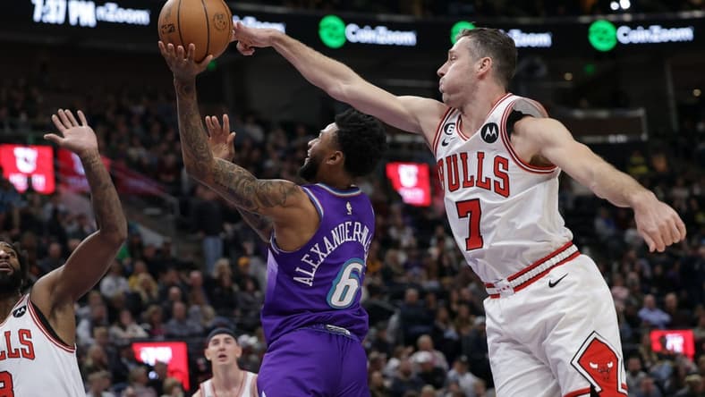Nov 28, 2022; Salt Lake City, Utah, USA; Chicago Bulls guard Goran Dragic (7) blocks the shot of Utah Jazz guard Nickeil Alexander-Walker (6) during the second quarter at Vivint Arena. Mandatory Credit: Chris Nicoll-USA TODAY Sports