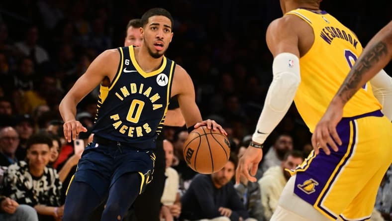 Nov 28, 2022; Los Angeles, California, USA; Indiana Pacers guard Tyrese Haliburton (0) controls the ball against Los Angeles Lakers guard Russell Westbrook (0) in the first half at Crypto.com Arena. Mandatory Credit: Richard Mackson-USA TODAY Sports