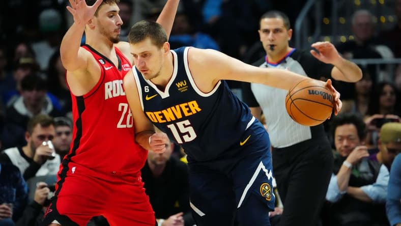Nov 28, 2022; Denver, Colorado, USA; Denver Nuggets center Nikola Jokic (15) drives at Houston Rockets center Alperen Sengun (28) in the third quarter at Ball Arena. Mandatory Credit: Ron Chenoy-USA TODAY Sports