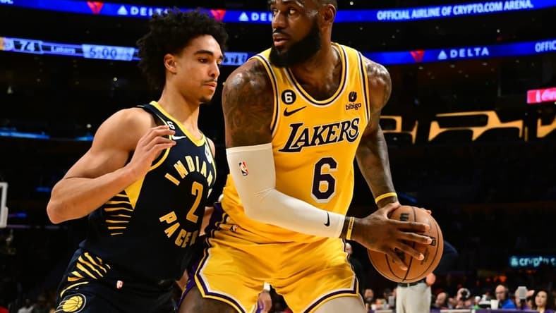 Nov 28, 2022; Los Angeles, California, USA; Los Angeles Lakers forward LeBron James (6) controls the ball against Indiana Pacers guard Andrew Nembhard (2) in the second half at Crypto.com Arena. Mandatory Credit: Richard Mackson-USA TODAY Sports