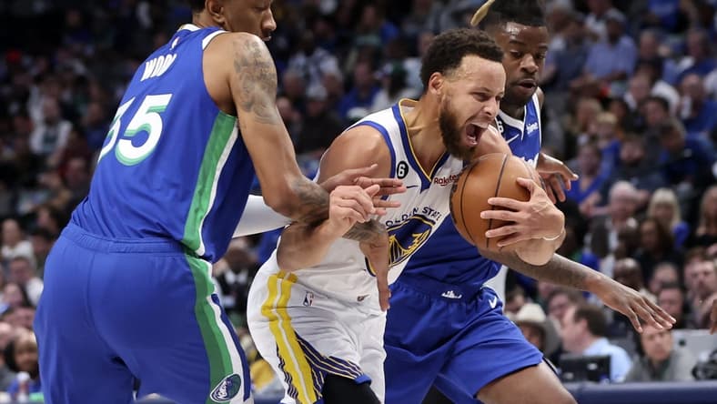 Nov 29, 2022; Dallas, Texas, USA; Golden State Warriors guard Stephen Curry (30) drives to the basket as Dallas Mavericks center Christian Wood (35) and Dallas Mavericks forward Reggie Bullock (25) defends during the first quarter at American Airlines Center. Mandatory Credit: Kevin Jairaj-USA TODAY Sports