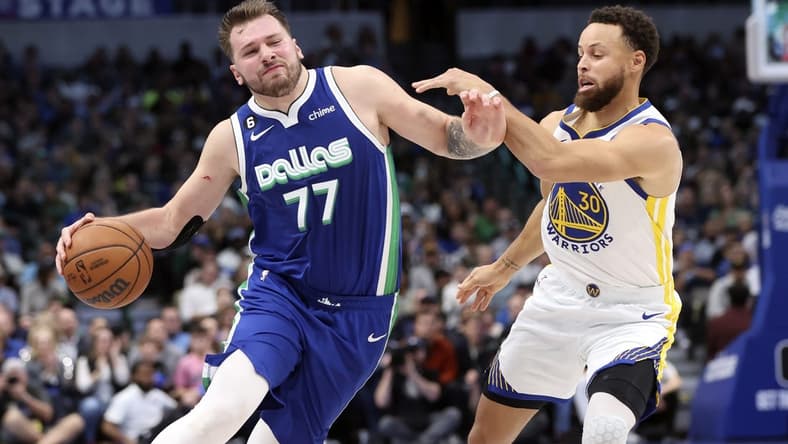 Nov 29, 2022; Dallas, Texas, USA;  Dallas Mavericks guard Luka Doncic (77) controls the ball as Golden State Warriors guard Stephen Curry (30) defends during the second half at American Airlines Center. Mandatory Credit: Kevin Jairaj-USA TODAY Sports