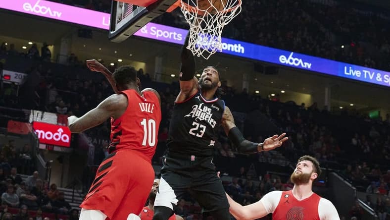 Nov 29, 2022; Portland, Oregon, USA;  LA Clippers forward Robert Covington (23) dunks the basketball during the first half against Portland Trail Blazers forward Nassir Little (10) at Moda Center. Mandatory Credit: Troy Wayrynen-USA TODAY Sports
