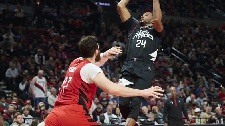 Nov 29, 2022; Portland, Oregon, USA; LA Clippers forward Norman Powell (24) shoots a basket during the first half against Portland Trail Blazers center Jusuf Nurkic (27) at Moda Center. Mandatory Credit: Troy Wayrynen-USA TODAY Sports
