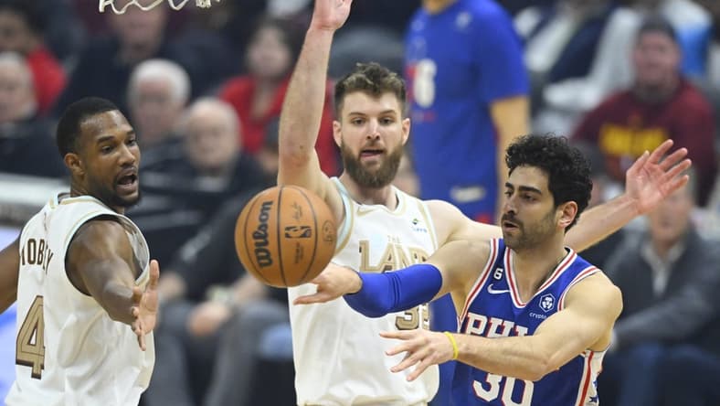 Nov 30, 2022; Cleveland, Ohio, USA; Philadelphia 76ers guard Furkan Korkmaz (30) throws a pass against Cleveland Cavaliers forward Evan Mobley (4) and forward Dean Wade (32) in the first quarter at Rocket Mortgage FieldHouse. Mandatory Credit: David Richard-USA TODAY Sports
