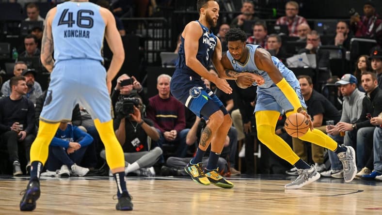 Nov 30, 2022; Minneapolis, Minnesota, USA; Memphis Grizzlies forward Jaren Jackson Jr. (13) controls the ball as Minnesota Timberwolves forward Kyle Anderson (5) defends during the first quarter at Target Center. Mandatory Credit: Nick Wosika-USA TODAY Sports