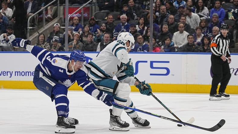 Nov 30, 2022; Toronto, Ontario, CAN; Toronto Maple Leafs defenseman Justin Holl (3) tries to stop San Jose Sharks forward Timo Meier (28) from getting off a shot during the second period at Scotiabank Arena. Mandatory Credit: John E. Sokolowski-USA TODAY Sports