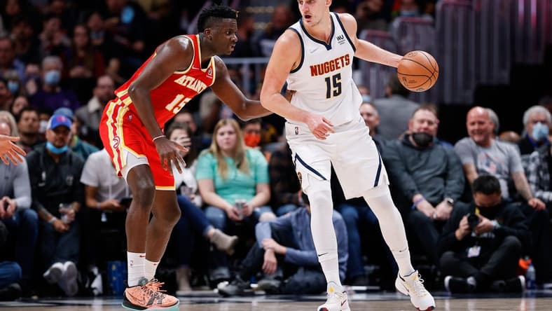 Nov 12, 2021; Denver, Colorado, USA; Denver Nuggets center Nikola Jokic (15) controls the ball as Atlanta Hawks center Clint Capela (15) guards in the third quarter at Ball Arena. Mandatory Credit: Isaiah J. Downing-USA TODAY Sports