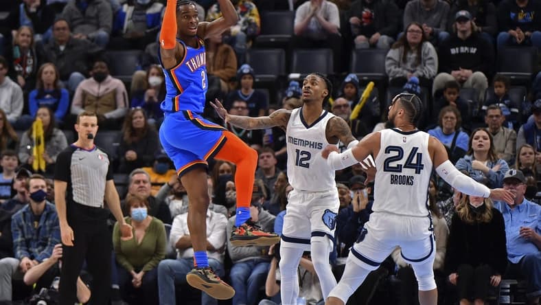 Dec 20, 2021; Memphis, Tennessee, USA; Oklahoma City Thunder guard Shai Gilgeous-Alexander (2) looks to pass against Memphis Grizzlies guard Ja Morant (12) during the second half at FedExForum. Mandatory Credit: Justin Ford-USA TODAY Sports