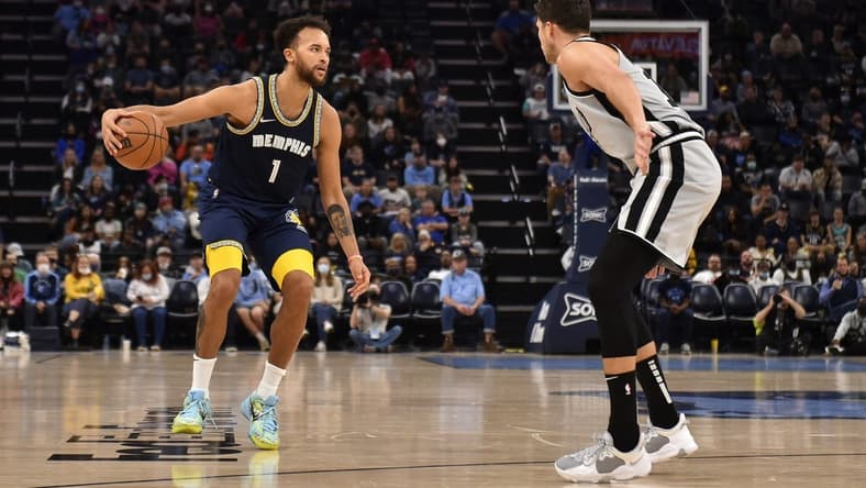 Dec 31, 2021; Memphis, Tennessee, USA; Memphis Grizzlies guard Tyrell Terry (1) controls the ball against San Antonio Spurs forward Doug McDermott (right) during the second half at FedExForum. Mandatory Credit: Justin Ford-USA TODAY Sports