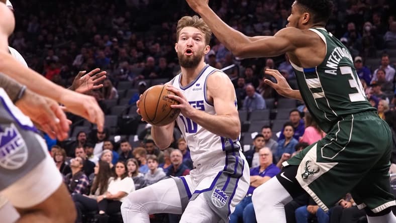 Mar 16, 2022; Sacramento, California, USA; Sacramento Kings center Domantas Sabonis (10) controls the ball against Milwaukee Bucks forward Giannis Antetokounmpo (34) during the first quarter at Golden 1 Center. Mandatory Credit: Kelley L Cox-USA TODAY Sports