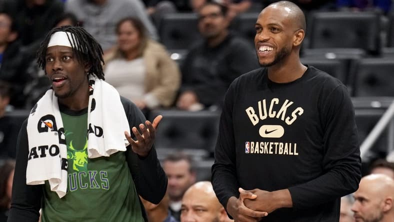 Apr 8, 2022; Detroit, Michigan, USA; Milwaukee Bucks forward Khris Middleton (22) smiles from the bench with guard Jrue Holiday (21) during the fourth quarter at Little Caesars Arena. Mandatory Credit: Raj Mehta-USA TODAY Sports