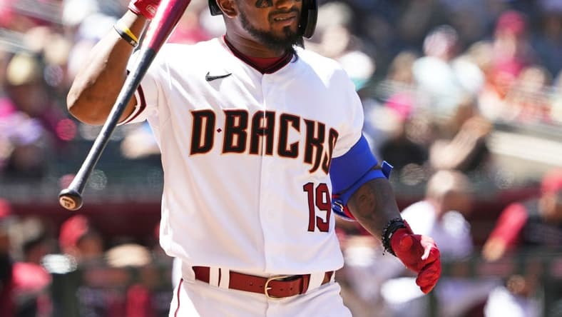 Apr 13, 2022; Phoenix, Arizona, USA; Arizona Diamondbacks Yonny Hernandez (19) hits his helmet after swinging at strike two against the Houston Astros in the third inning at Chase Field. Mandatory Credit: Rob Schumacher-Arizona Republic