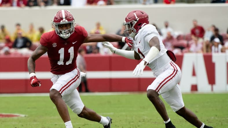 Apr 16, 2022; Tuscaloosa, Alabama, USA;  Crimson wide receiver Traeshon Holden (11) is defended by White defensive back Kool-Aid McKinstry (1) during the A-Day game at Bryant-Denny Stadium. Mandatory Credit: Gary Cosby Jr.-USA TODAY Sports