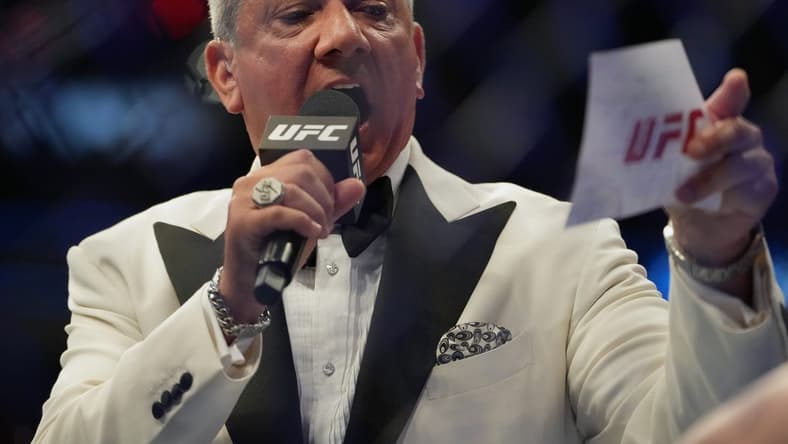 Jul 2, 2022; Las Vegas, Nevada, USA; Ring announcer Bruce Buffer introduces Jessica-Rose Clark (red gloves) and Julija Stoliarenko (blue gloves) before a bout during UFC 276 at T-Mobile Arena. Mandatory Credit: Stephen R. Sylvanie-USA TODAY Sports