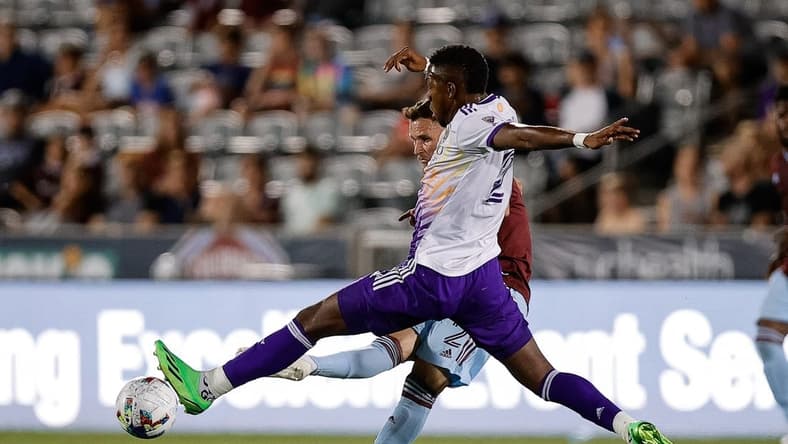 Jul 13, 2022; Commerce City, Colorado, USA; Colorado Rapids defender Keegan Rosenberry (2) kicks the ball as Orlando City midfielder Andres Perea (21) defends in the second half at Dick's Sporting Goods Park. Mandatory Credit: Isaiah J. Downing-USA TODAY Sports