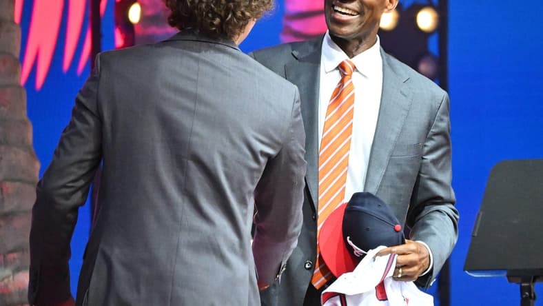 Jul 17, 2022; Los Angeles, CA, USA;  Former Atlanta Braves player Fred McGriff presents JR Ritchie with his jersey after he was selected by the Atlanta Braves as the 35th pick of the MLB draft at XBox Plaza at LA Live. Mandatory Credit: Jayne Kamin-Oncea-USA TODAY Sports