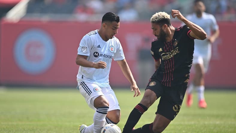 Jul 30, 2022; Chicago, Illinois, USA; Atlanta United FC defender George Campbell (32) moves in to kick the ball away from Chicago Fire FC forward Jairo Torres (7) in the first half at Soldier Field. Mandatory Credit: Jamie Sabau-USA TODAY Sports