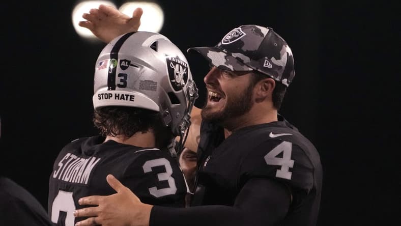 Aug 4, 2022; Canton, Ohio, USA; Las Vegas Raiders quarterback Jarrett Stidham (3) celebrates his touchdown in the second quarter with quarterback Derek Carr (4) during the Hall of Fame game against the Jacksonville Jaguars at Tom Benson Hall of Fame Stadium. Mandatory Credit: Kirby Lee-USA TODAY Sports