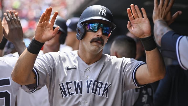 Aug 7, 2022; St. Louis, Missouri, USA;  New York Yankees designated hitter Matt Carpenter (24) is congratulated by teammates after hitting a one run sacrifice fly against the St. Louis Cardinals during the first inning at Busch Stadium. Mandatory Credit: Jeff Curry-USA TODAY Sports