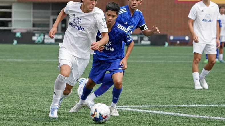 Aug 10, 2022; Blaine, MN, USA; MLS Next East player Favian Loyola (16) of Orlando City dribbles the ball against MLS Next West during the second half of the 2022 MLS NEXT All-Star Game at National Sports Center Indoor Sports Hall. Mandatory Credit: Kirby Lee-USA TODAY Sports
