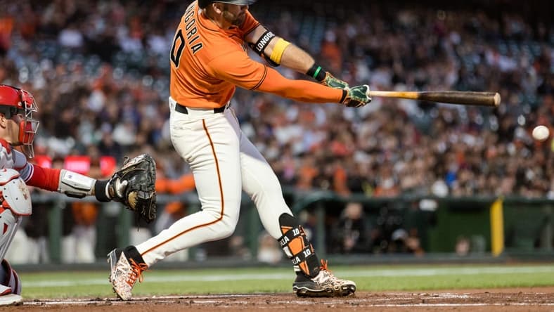 Sep 2, 2022; San Francisco, California, USA; San Francisco Giants third baseman Evan Longoria (10) hits an RBI line drive double against the Philadelphia Phillies during the first inning at Oracle Park. Mandatory Credit: John Hefti-USA TODAY Sports