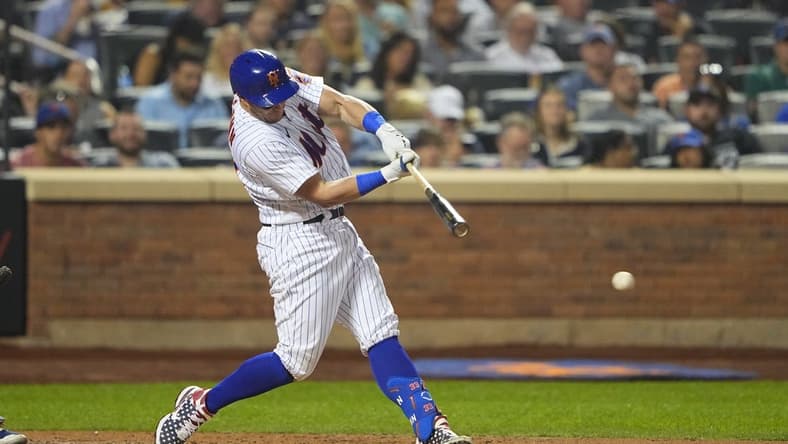 Sep 12, 2022; New York City, New York, USA; New York Mets catcher James McCann (33) hits an RBI single against the Chicago Cubs during the fourth inning at Citi Field. Mandatory Credit: Gregory Fisher-USA TODAY Sports