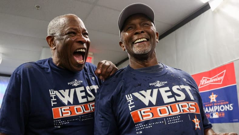 Sep 19, 2022; St. Petersburg, Florida, USA; Houston Astros manager Dusty Baker Jr. (12) and third base coach Gary Pettis (8) celebrate winning the American League West at Tropicana Field. Mandatory Credit: Nathan Ray Seebeck-USA TODAY Sports