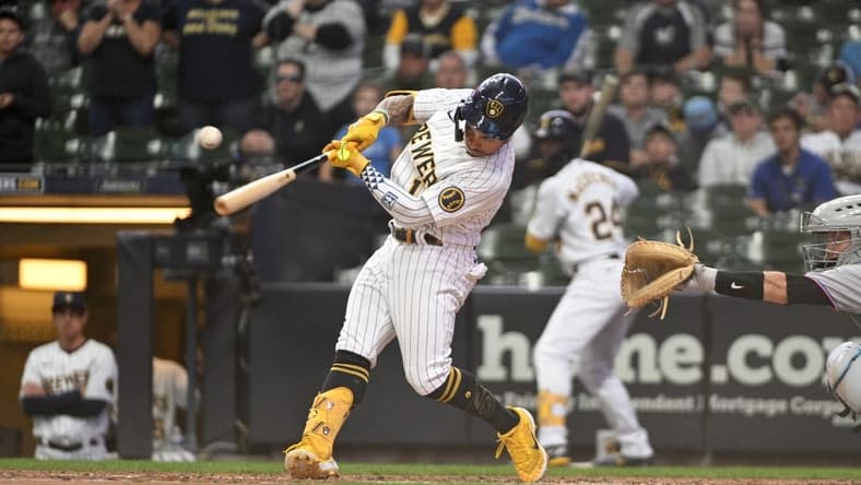 Oct 2, 2022; Milwaukee, Wisconsin, USA; Milwaukee Brewers second baseman Kolten Wong (16) hits an RBI single to tie the game in the ninth inning against the Milwaukee Brewers at American Family Field. Mandatory Credit: Michael McLoone-USA TODAY Sports