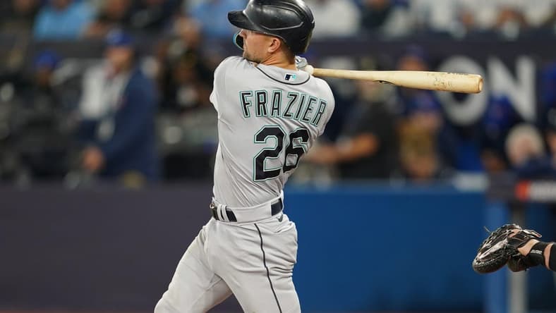 Oct 7, 2022; Toronto, Ontario, CAN; Seattle Mariners second baseman Adam Frazier (26) hits a single in the second inning against the Toronto Blue Jays during game one of the Wild Card series for the 2022 MLB Playoffs at Rogers Centre. Mandatory Credit: Nick Turchiaro-USA TODAY Sports
