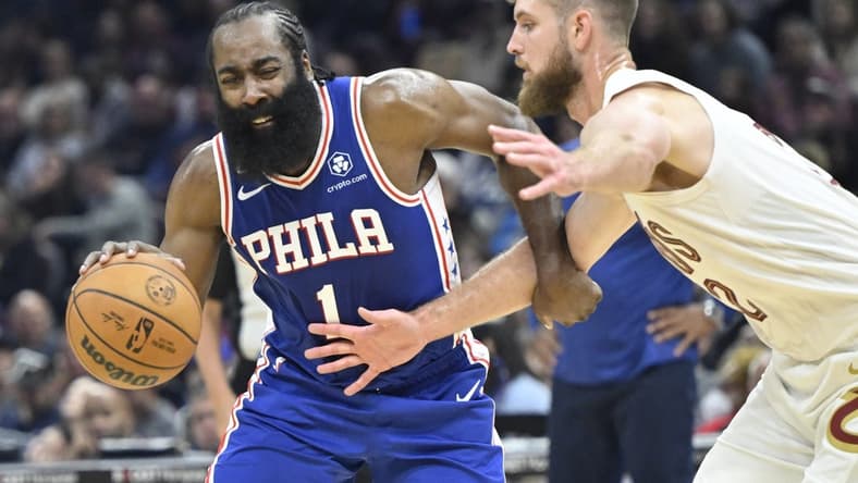 Oct 10, 2022; Cleveland, Ohio, USA; Philadelphia 76ers guard James Harden (1) drives against Cleveland Cavaliers forward Dean Wade (32) in the second quarter at Rocket Mortgage FieldHouse. Mandatory Credit: David Richard-USA TODAY Sports