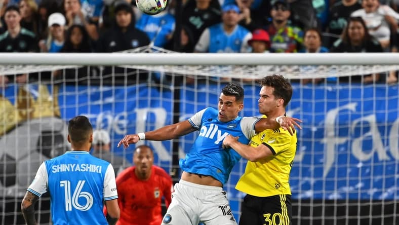 Oct 5, 2022; Charlotte, North Carolina, USA; Charlotte FC forward Daniel Rios (12) and Columbus Crew defender Will Sands (30) fight for the header in the second half at Bank of America Stadium. Mandatory Credit: Bob Donnan-USA TODAY Sports