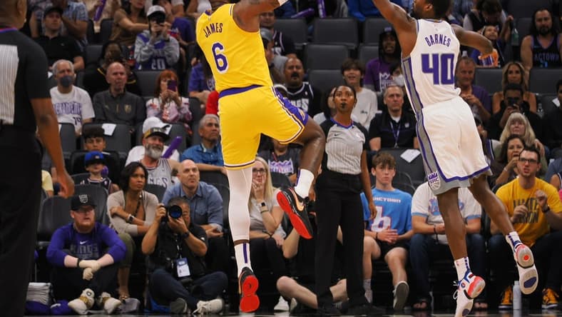 Oct 14, 2022; Sacramento, California, USA; Los Angeles Lakers small forward LeBron James (6) scores a basket against Sacramento Kings power forward Harrison Barnes (40) during the first quarter at Golden 1 Center. Mandatory Credit: Kelley L Cox-USA TODAY Sports