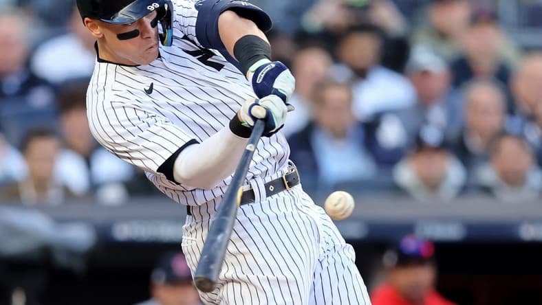 Oct 18, 2022; Bronx, New York, USA; New York Yankees right fielder Aaron Judge (99) hits a home run against the Cleveland Guardians during the second inning in game five of the ALDS for the 2022 MLB Playoffs at Yankee Stadium. Mandatory Credit: Brad Penner-USA TODAY Sports