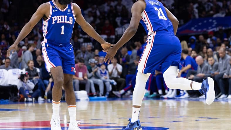 Oct 20, 2022; Philadelphia, Pennsylvania, USA; Philadelphia 76ers guard James Harden (1) congratulates center Joel Embiid (21) after scoring against the Milwaukee Bucks during the first quarter at Wells Fargo Center. Mandatory Credit: Bill Streicher-USA TODAY Sports