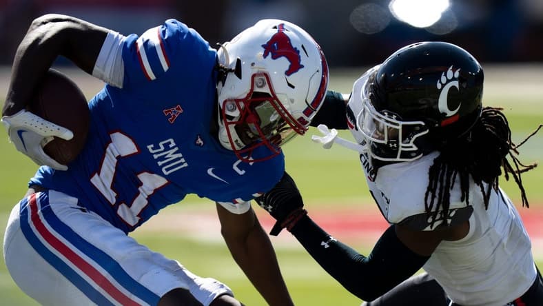 Cincinnati Bearcats cornerback Arquon Bush (9) tackles Southern Methodist Mustangs wide receiver Rashee Rice (11) in the fourth quarter of the American Athletic Conference game at Gerald J. Ford Stadium in Dallas on Saturday, Oct. 22, 2022. Cincinnati Bearcats defeated Southern Methodist Mustangs 29-27.

Cincinnati Bearcats At Southern Methodist Mustangs 730