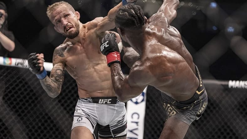 Oct 22, 2022; Abu Dhabi, UAE; Aljamain Sterling (red gloves) and T.J. Dillashaw (blue gloves) during UFC 280 at Etihad Arena. Mandatory Credit: Craig Kidwell-USA TODAY Sports